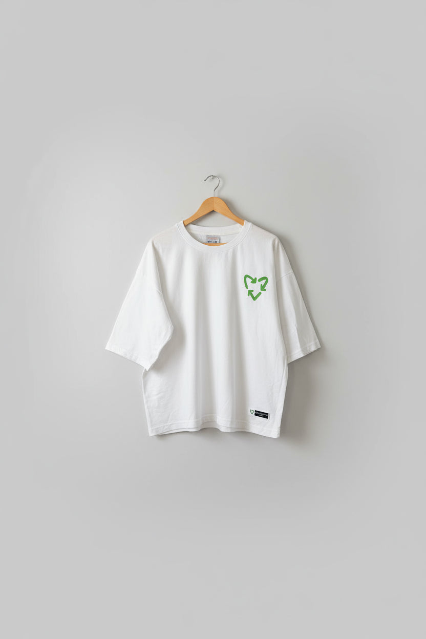 White t-shirt with green logo on a textured brown background with 'Sustainable Trash' text.